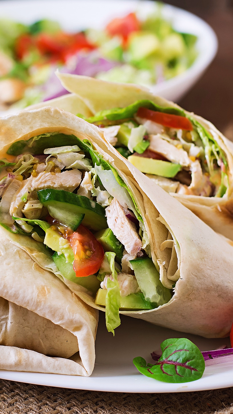 To wraps med kjøtt og grønnsaker på en hvit tallerken