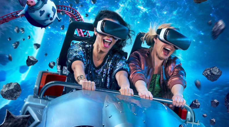 To personer med VR-briller på en berg-og-dal-bane i verdensrommet med en tegneserieku